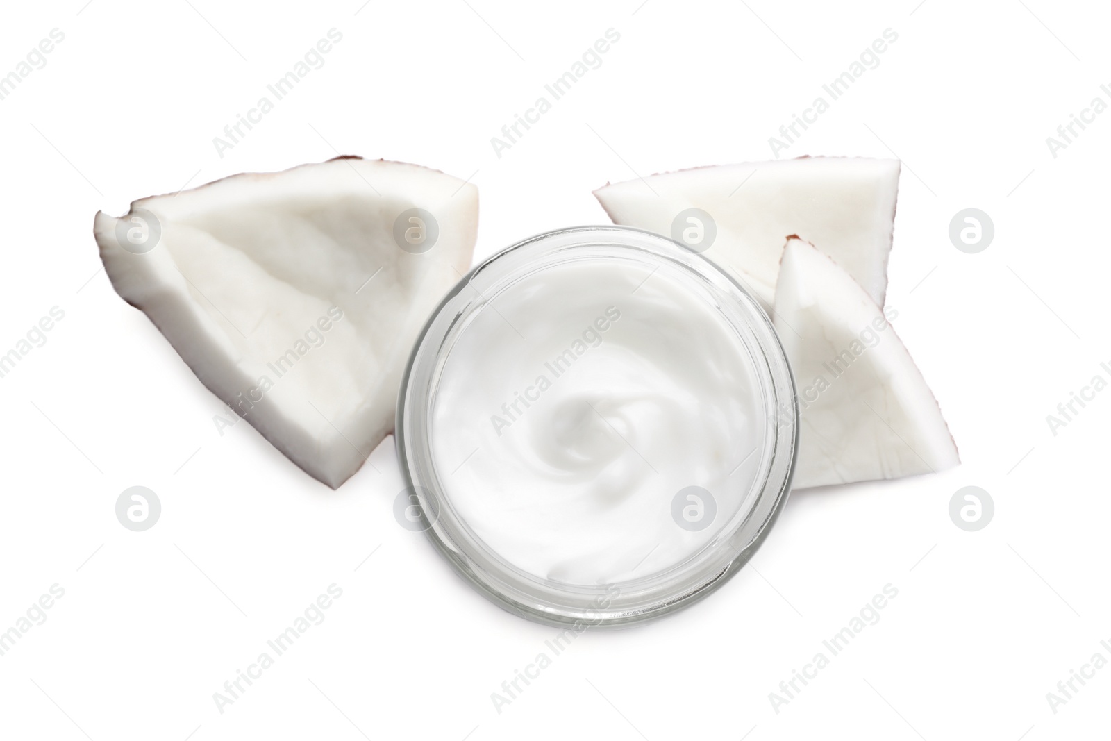 Photo of Jar of hand cream and coconut pieces on white background, top view