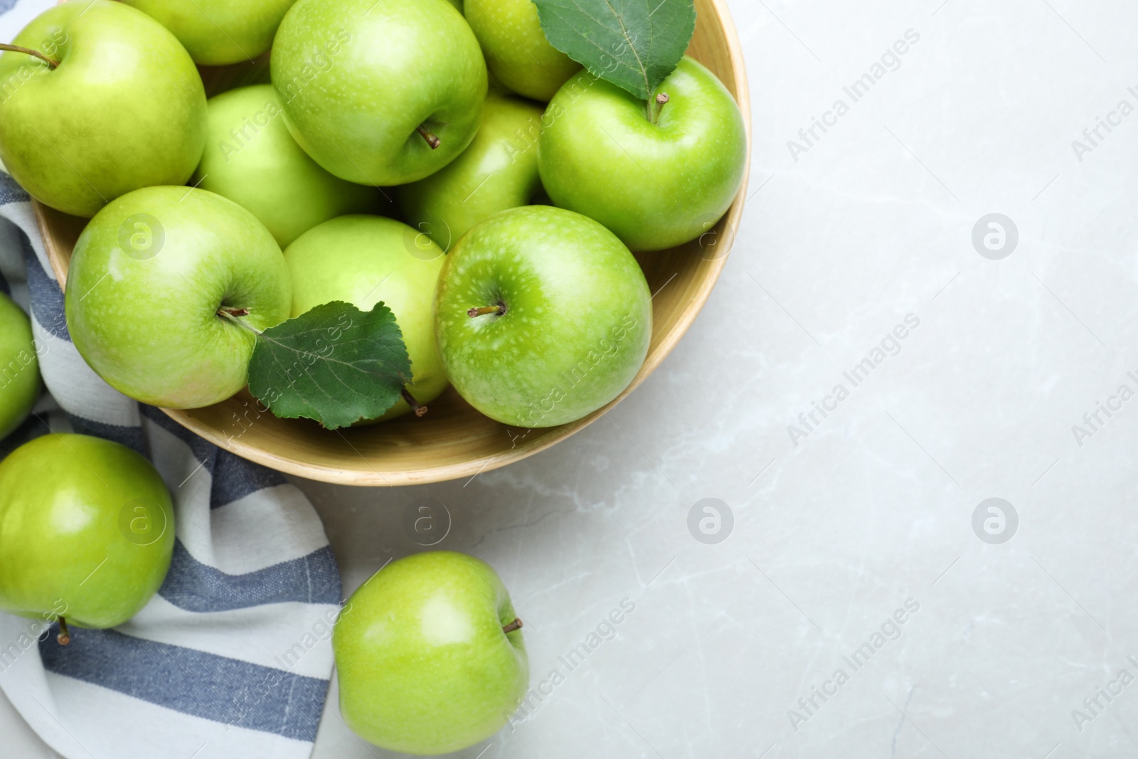 Photo of Flat lay composition with juicy green apples on white table, space for text
