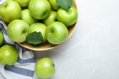 Flat lay composition with juicy green apples on white table, space for text