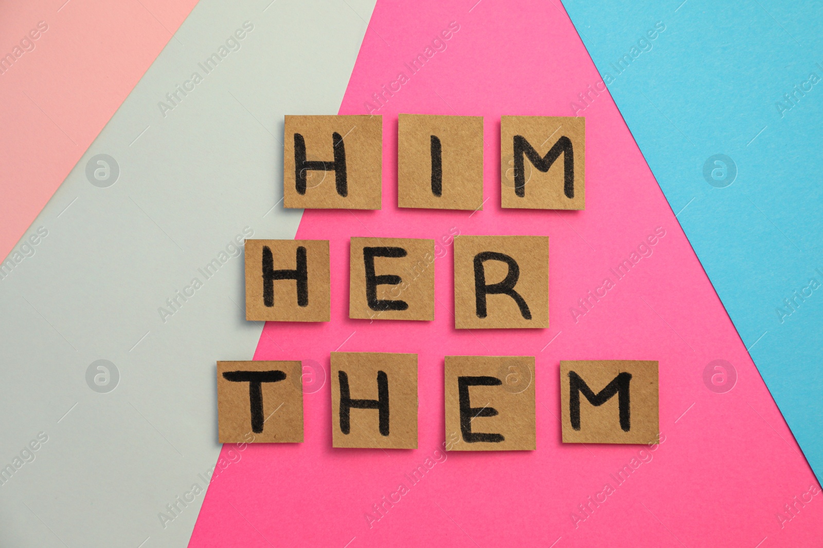 Photo of Paper cards with pronouns on color background, flat lay