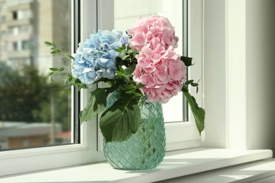 Photo of Bouquet with beautiful hortensia flowers on window sill