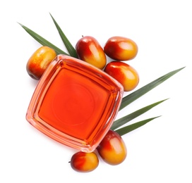 Palm oil in glass bowl and fruits on white background, top view