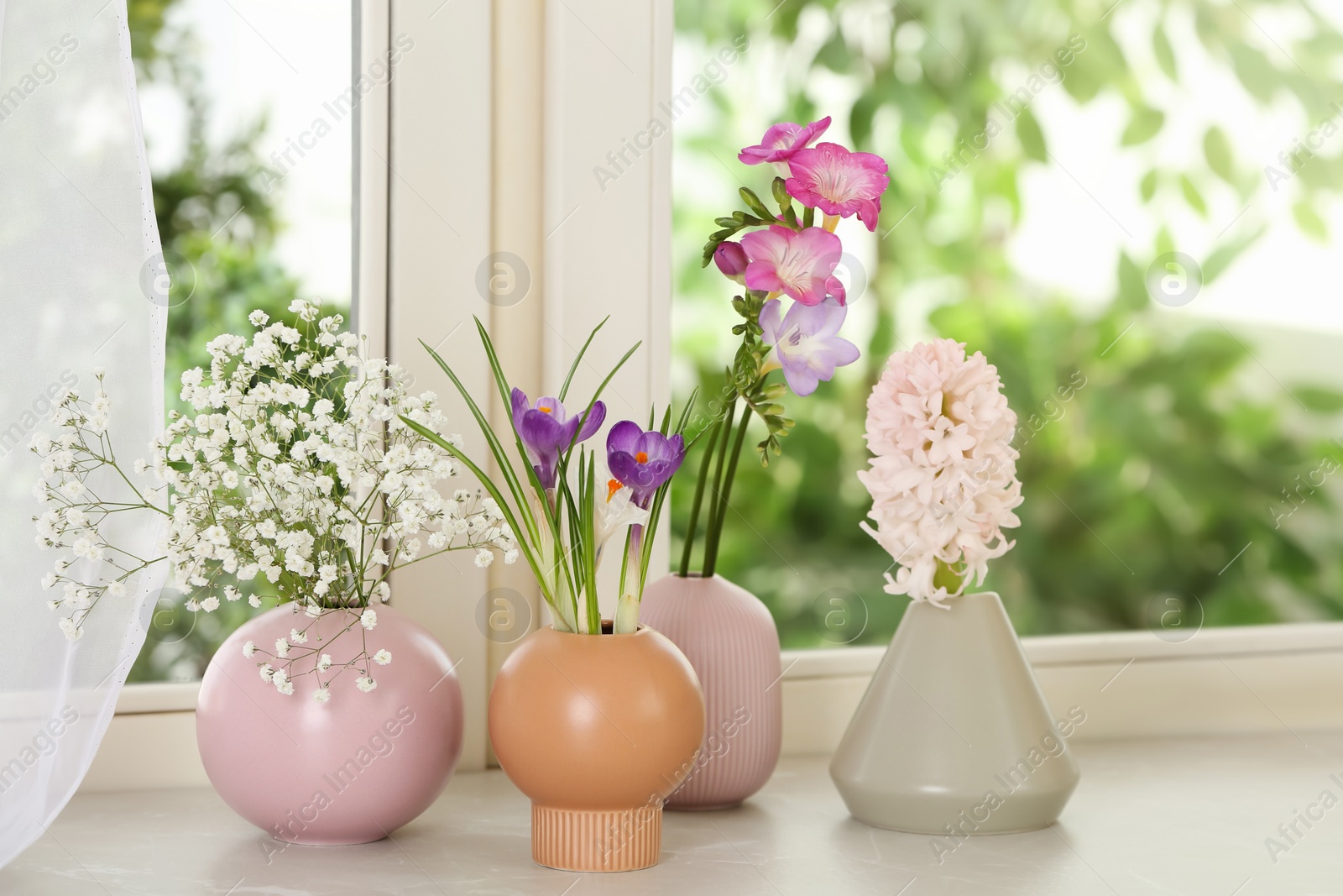 Photo of Beautiful fresh flowers on window sill indoors