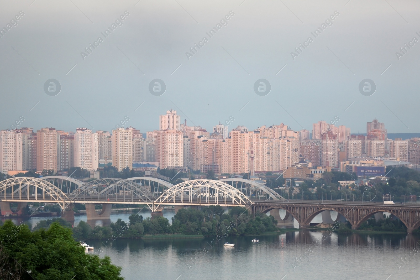 Photo of KYIV, UKRAINE - MAY 23, 2019: Beautiful view of Darnitsky railway bridge over Dnipro river