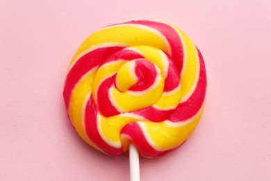 Photo of Sweet colorful lollipop on pink background, top view