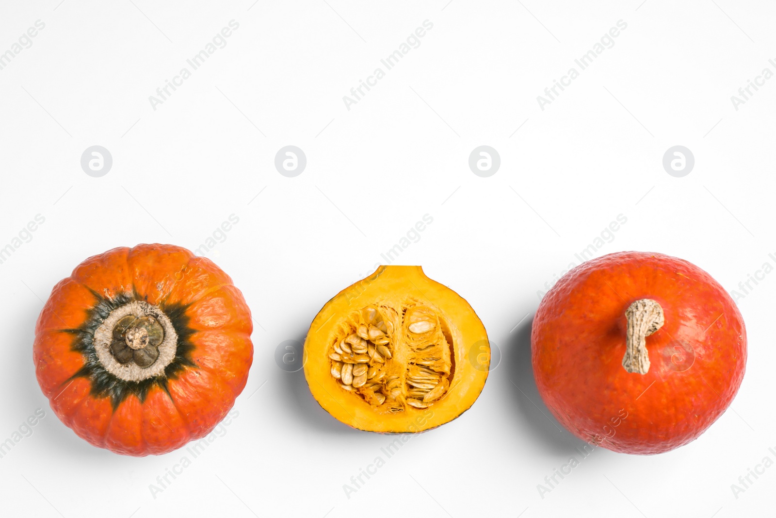 Photo of Fresh ripe pumpkins on white background, top view. Holiday decoration