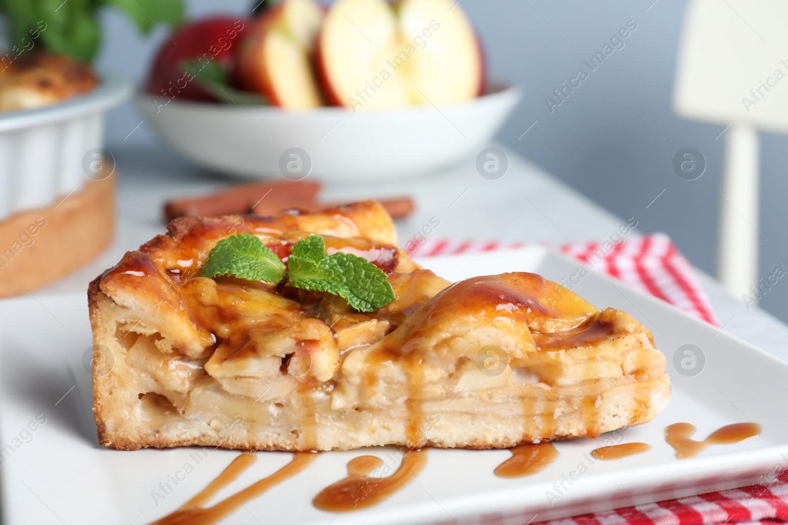 Photo of Slice of traditional apple pie on plate, closeup