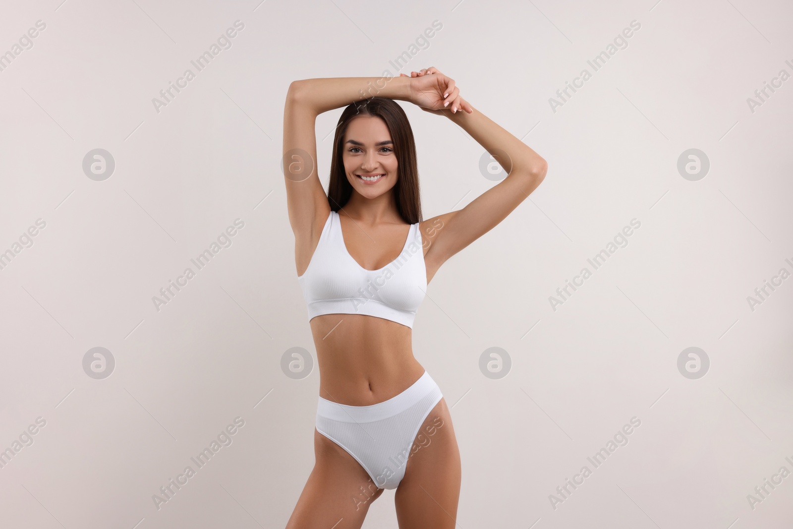 Photo of Young woman in stylish bikini on white background
