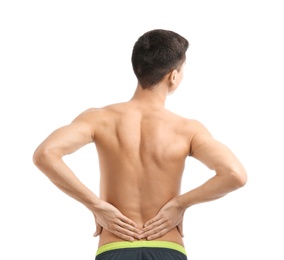 Young man suffering from back pain on white background