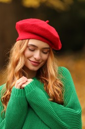 Photo of Portrait of beautiful woman wearing autumn sweater outdoors