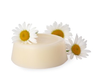 Photo of Solid shampoo bar and chamomiles on white background. Hair care