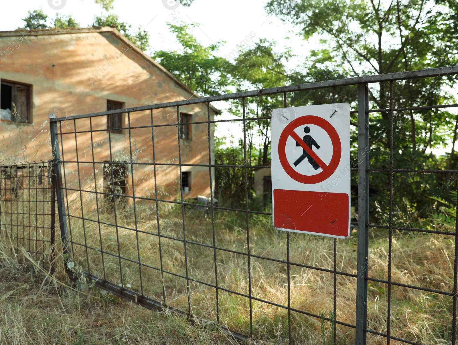 Photo of Sign Access forbidden all unauthorized persons with text in Italian attached to fence