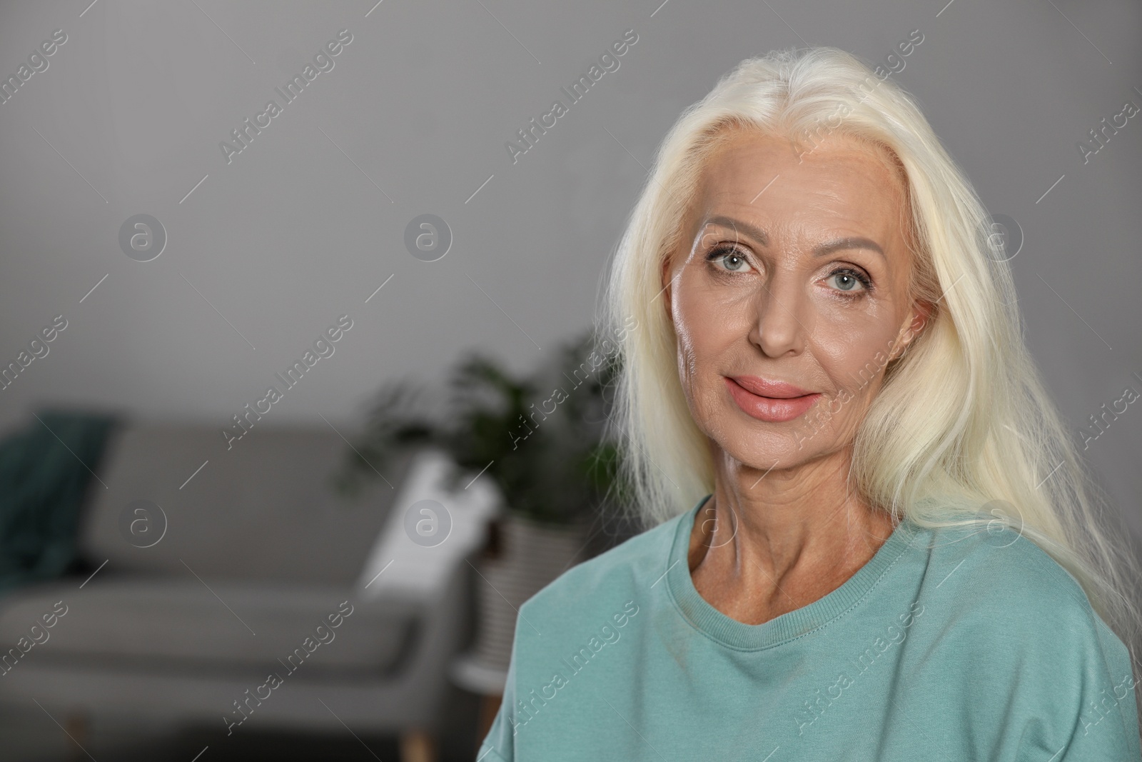 Photo of Portrait of elegant mature woman at home. Space for text