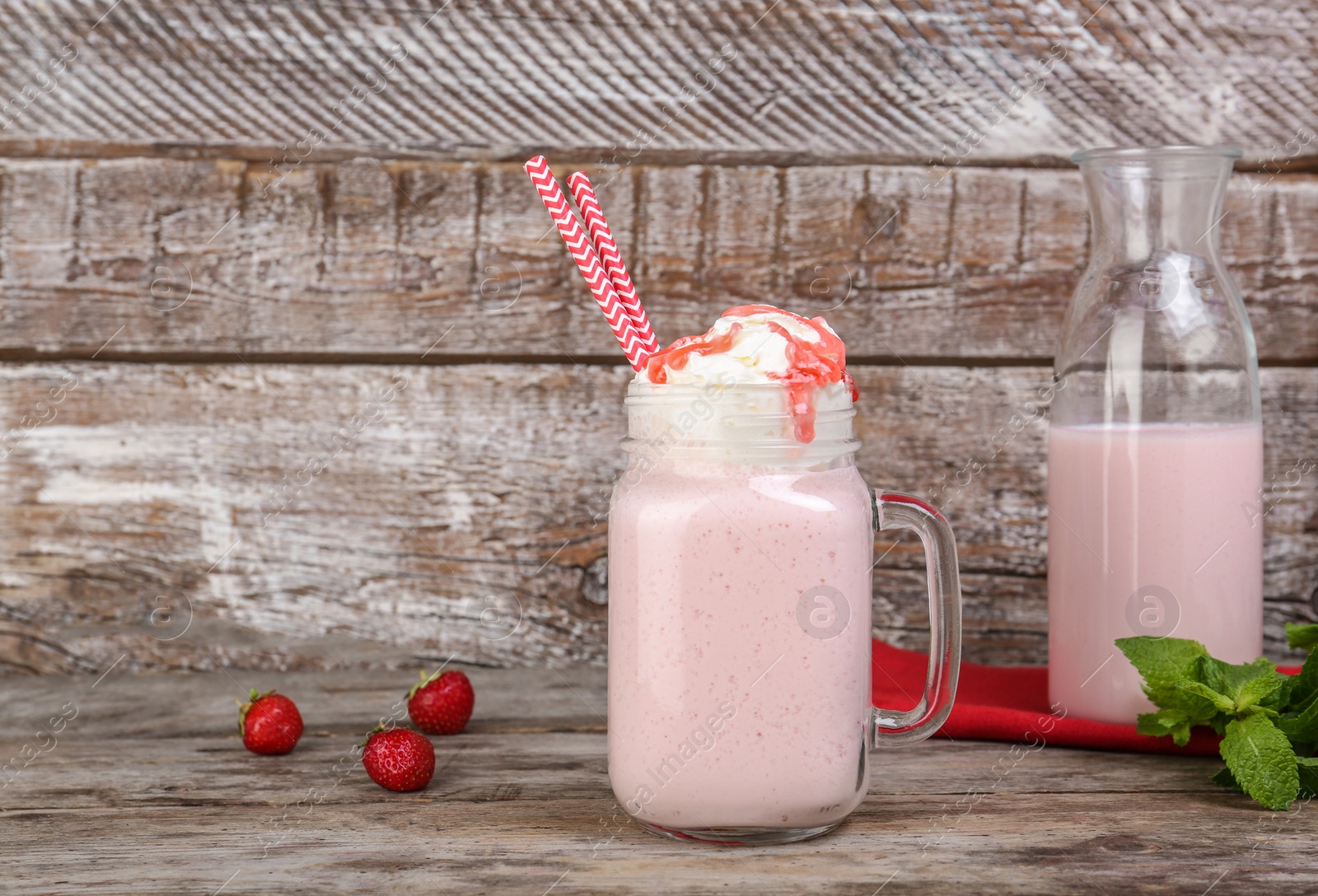 Photo of Glassware with delicious milk shake on table