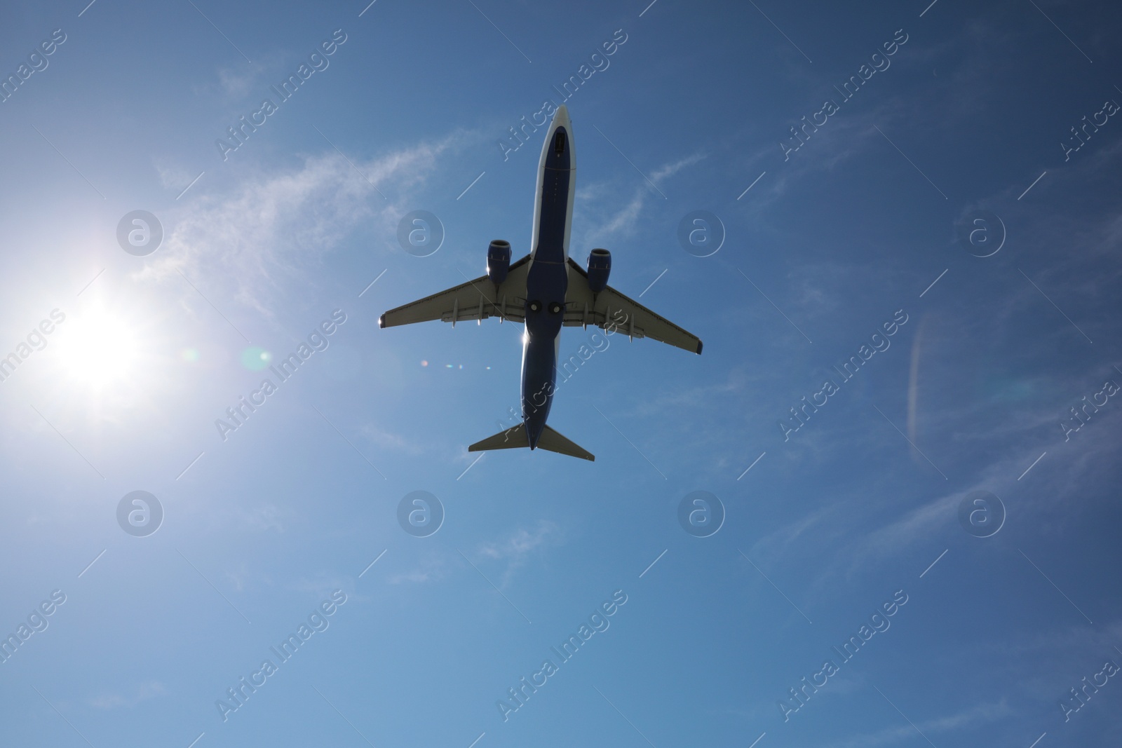 Photo of Modern white airplane flying in sky, bottom view