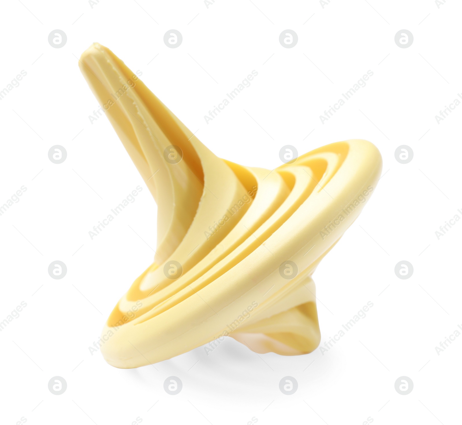 Photo of One pale yellow spinning top on white background