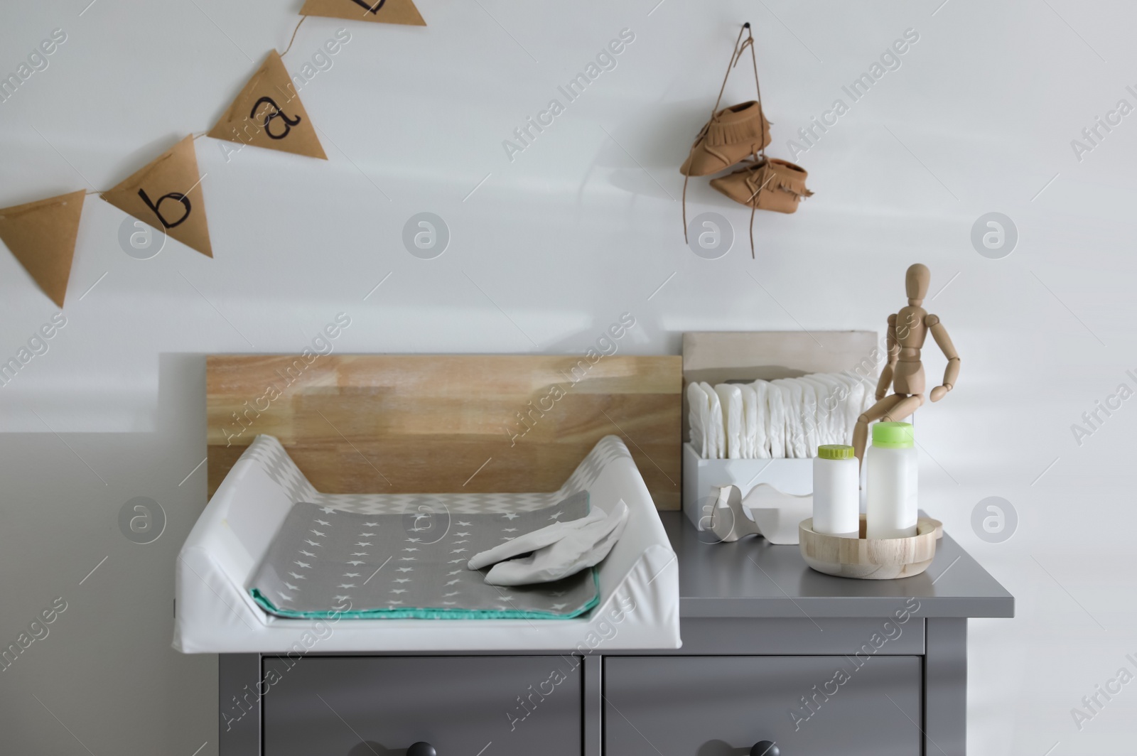 Photo of Modern changing table in baby room interior