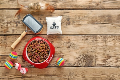 Cat's accessories and food on wooden background