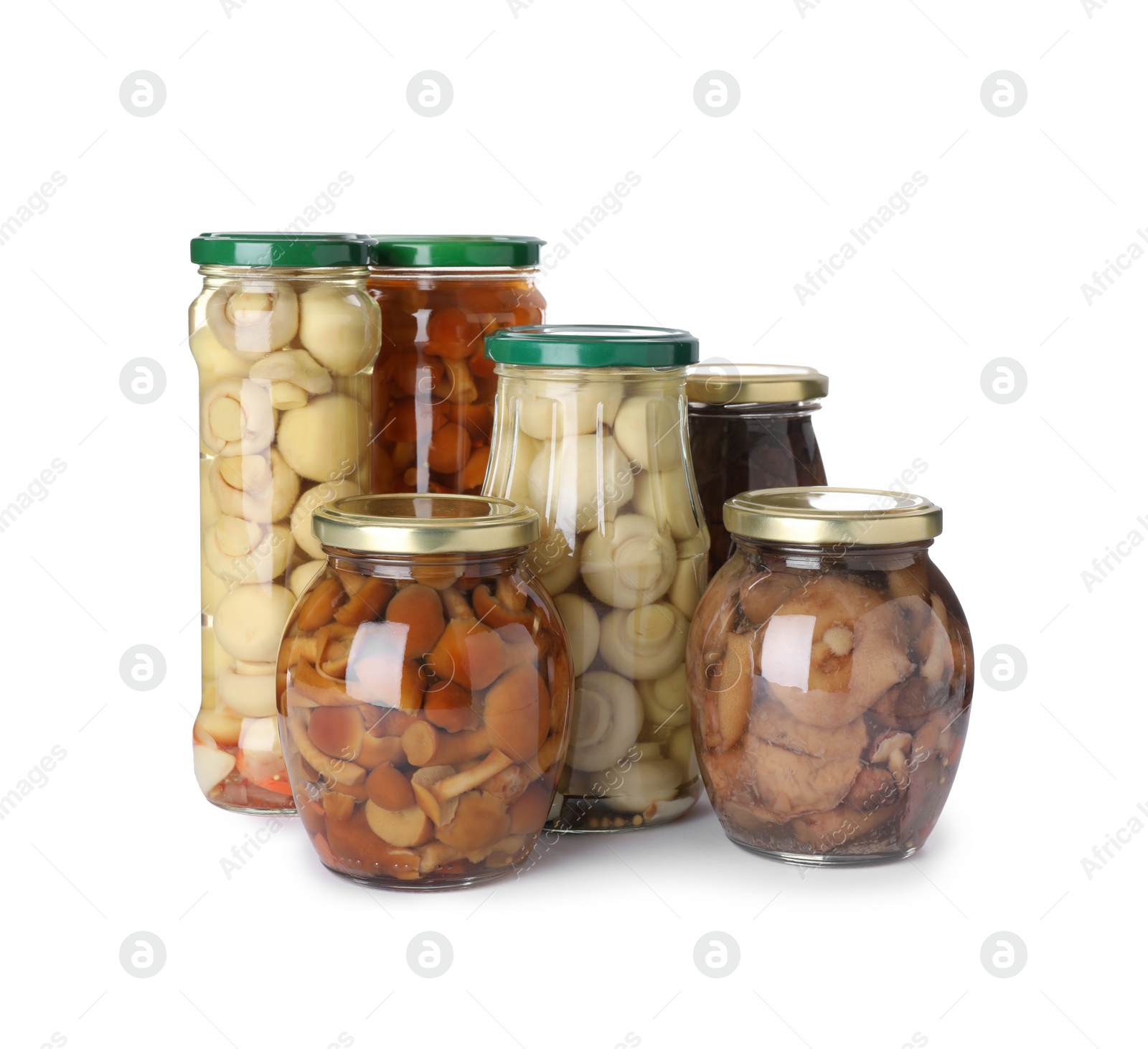 Photo of Jars with marinated mushrooms on white background