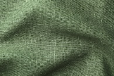 Photo of Texture of green crumpled fabric as background, top view