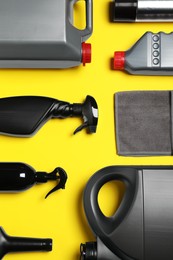 Different car products on yellow background, flat lay