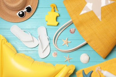 Photo of Flat lay composition with beach accessories on wooden background