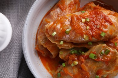 Photo of Delicious stuffed cabbage rolls cooked with tomato sauce on table, top view