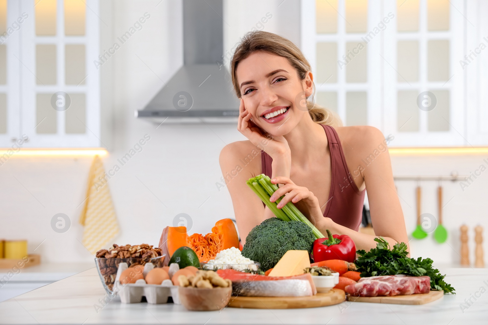 Photo of Woman with healthy food in kitchen. Keto diet