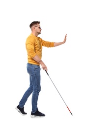 Photo of Blind man in dark glasses with walking cane on white background