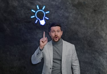 Idea generation. Man and illustration of light bulb on grey background