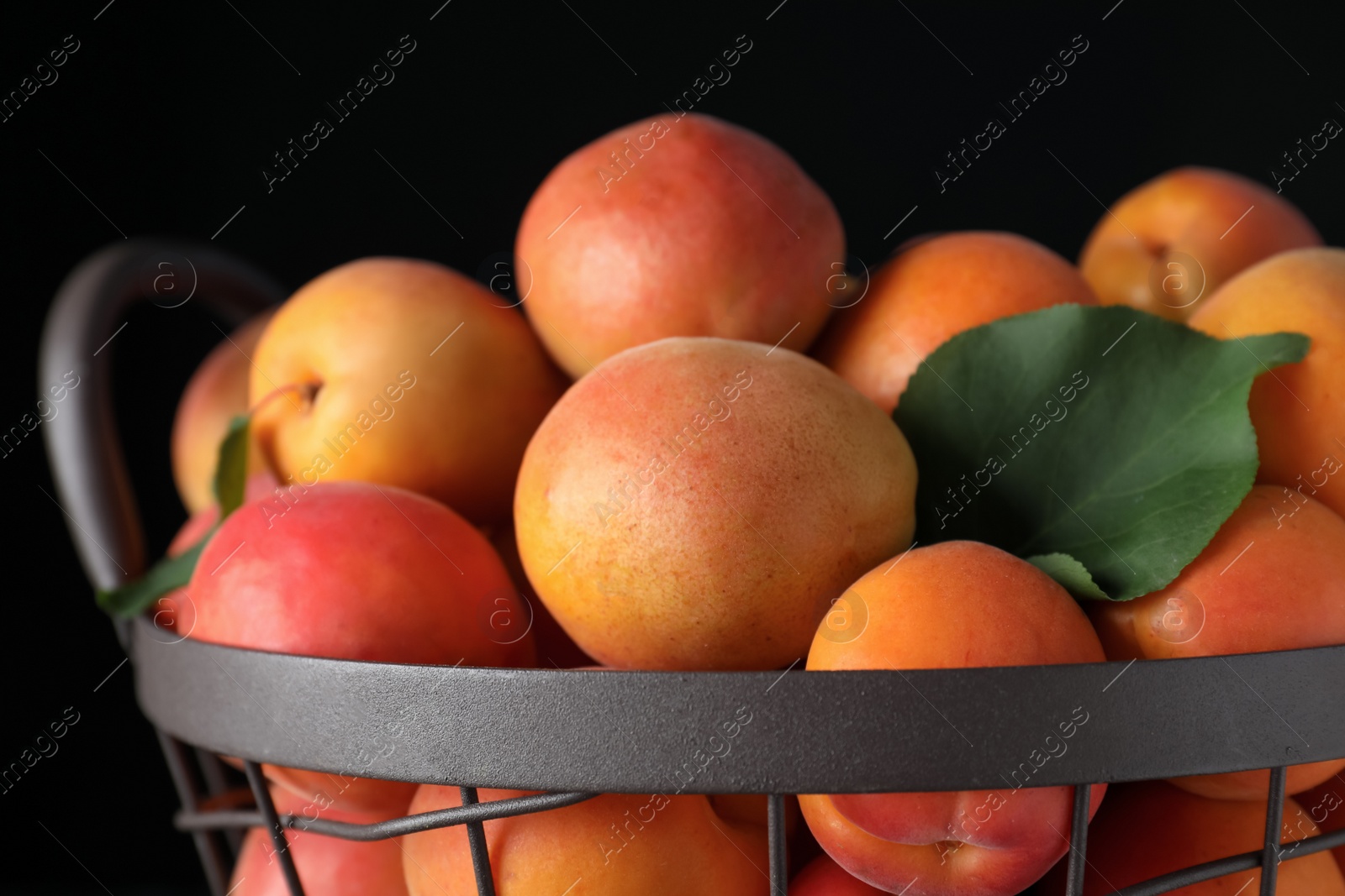 Photo of Delicious fresh ripe apricots on black background, closeup