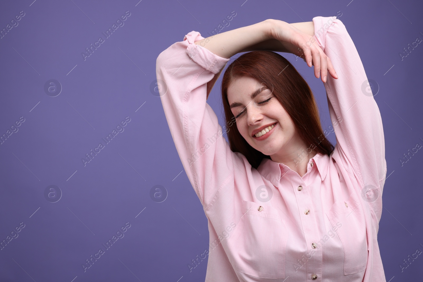 Photo of Portrait of smiling woman on purple background. Space for text