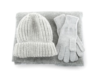 Photo of Woolen gloves, hat and scarf on white background, top view. Winter clothes