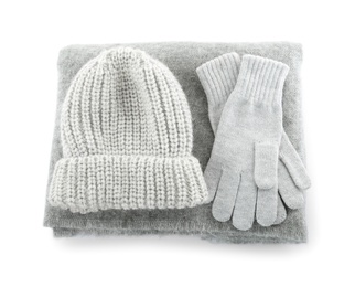 Woolen gloves, hat and scarf on white background, top view. Winter clothes