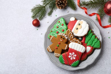 Tasty homemade Christmas cookies and decor on light grey table, flat lay. Space for text