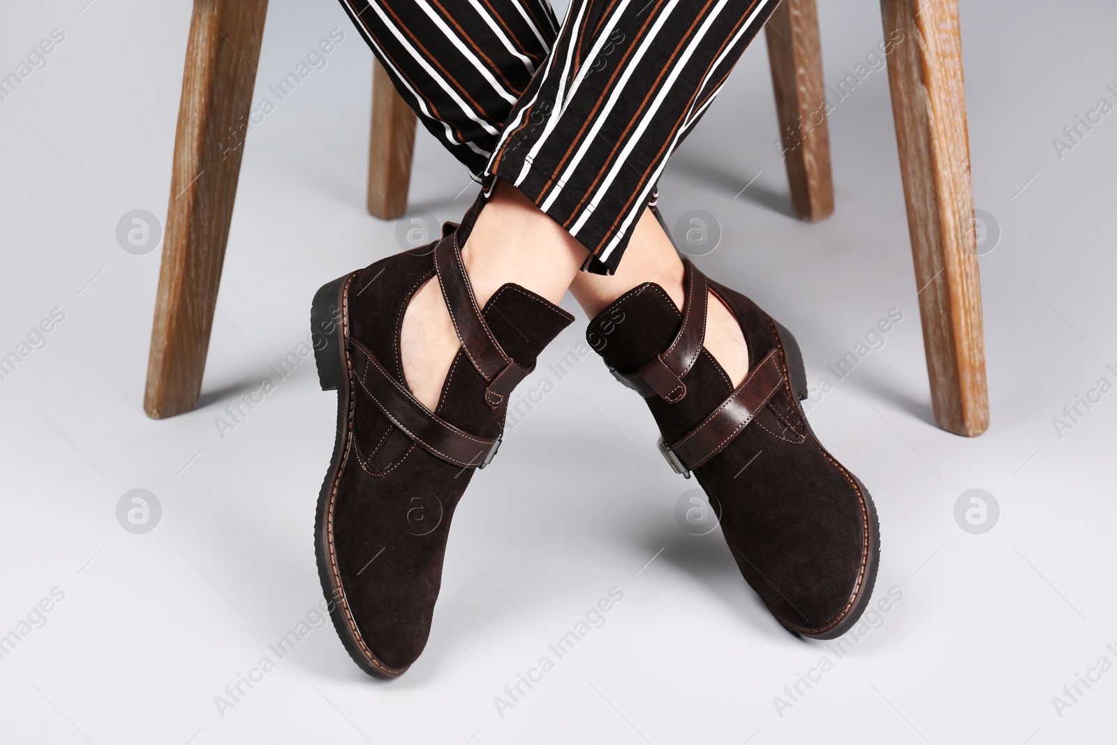 Photo of Woman in stylish shoes on light background