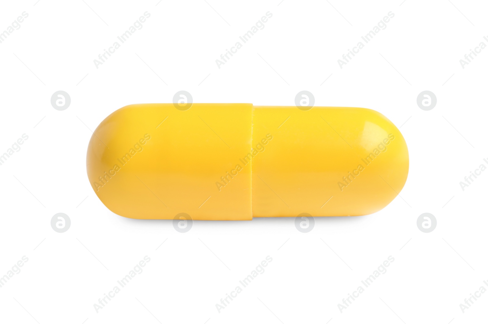 Photo of One yellow pill on white background. Medicinal treatment