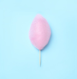 Sweet pink cotton candy on light blue background, top view