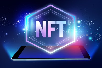 Image of Abbreviation NFT (non-fungible token) over tablet computer on blue backgorund