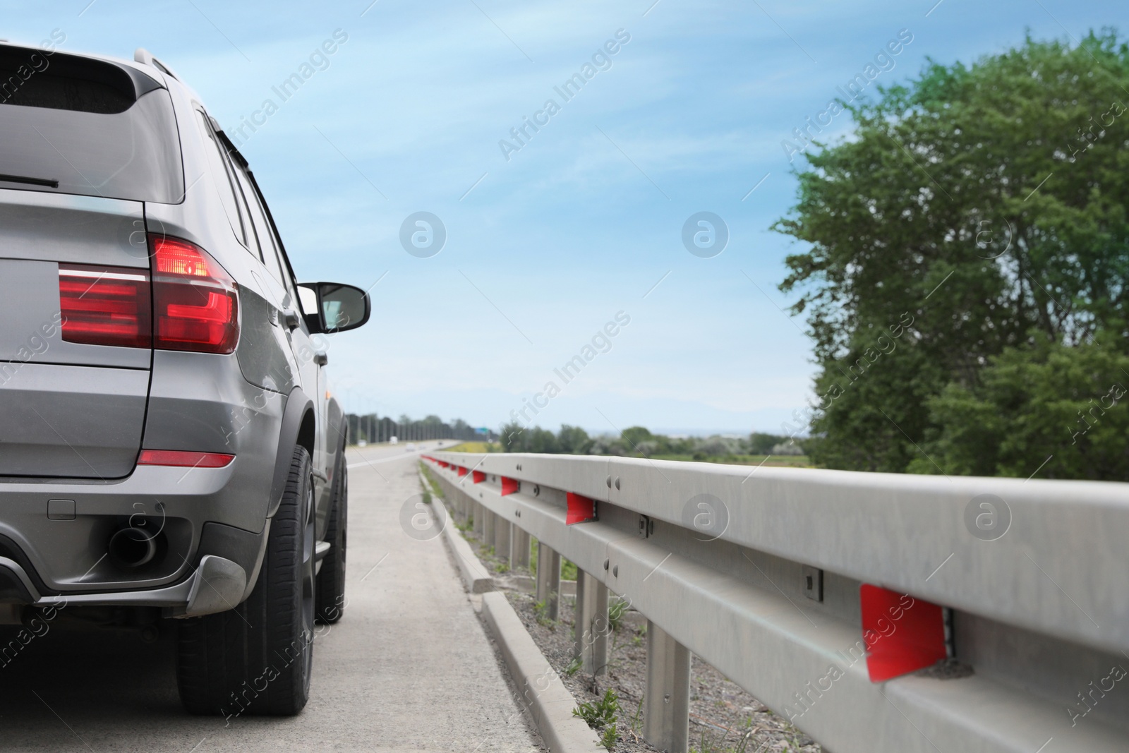 Photo of Grey modern car parked on asphalt road