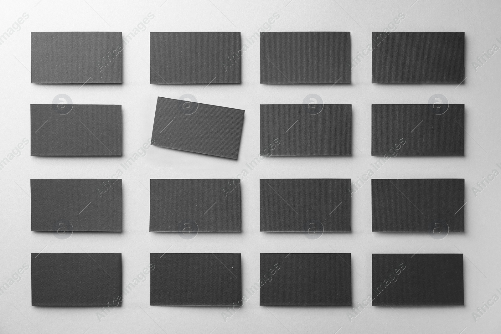 Photo of Blank black business cards on light background, flat lay. Mockup for design