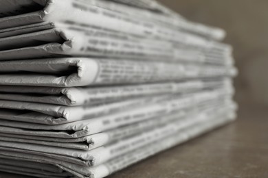 Photo of Stack of newspapers on marble table, closeup. Journalist's work