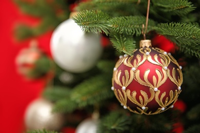 Beautifully decorated Christmas tree against color background, closeup