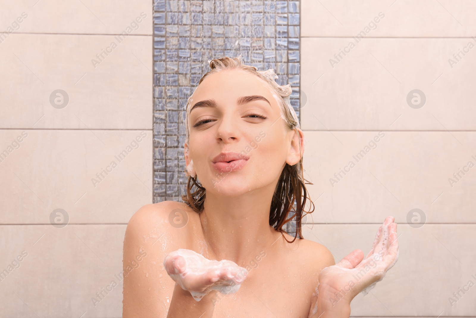 Photo of Beautiful young woman taking shower at home