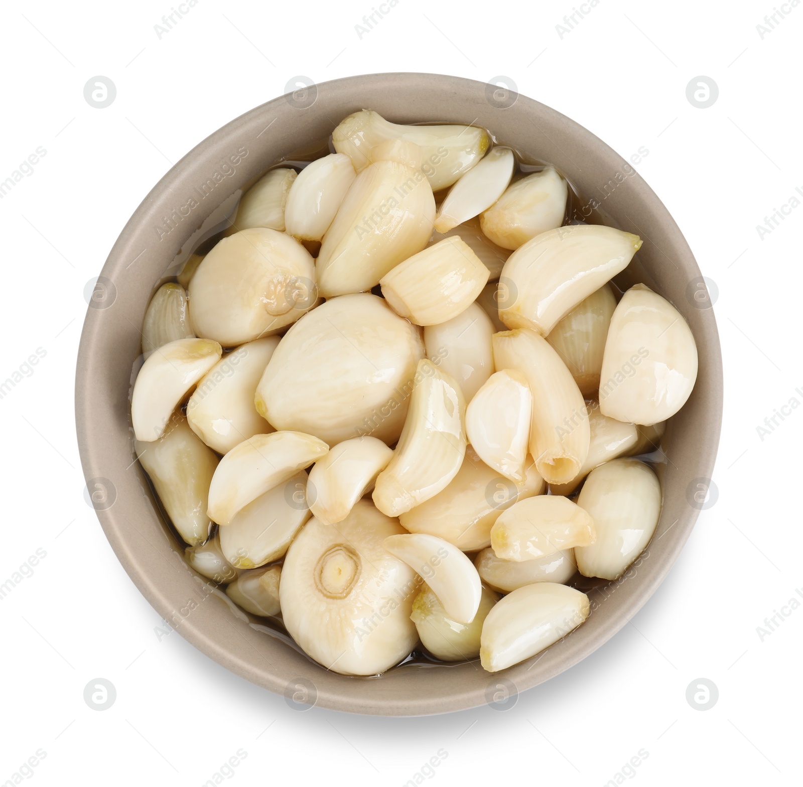 Photo of Peeled garlic cloves with honey in bowl isolated on white, top view