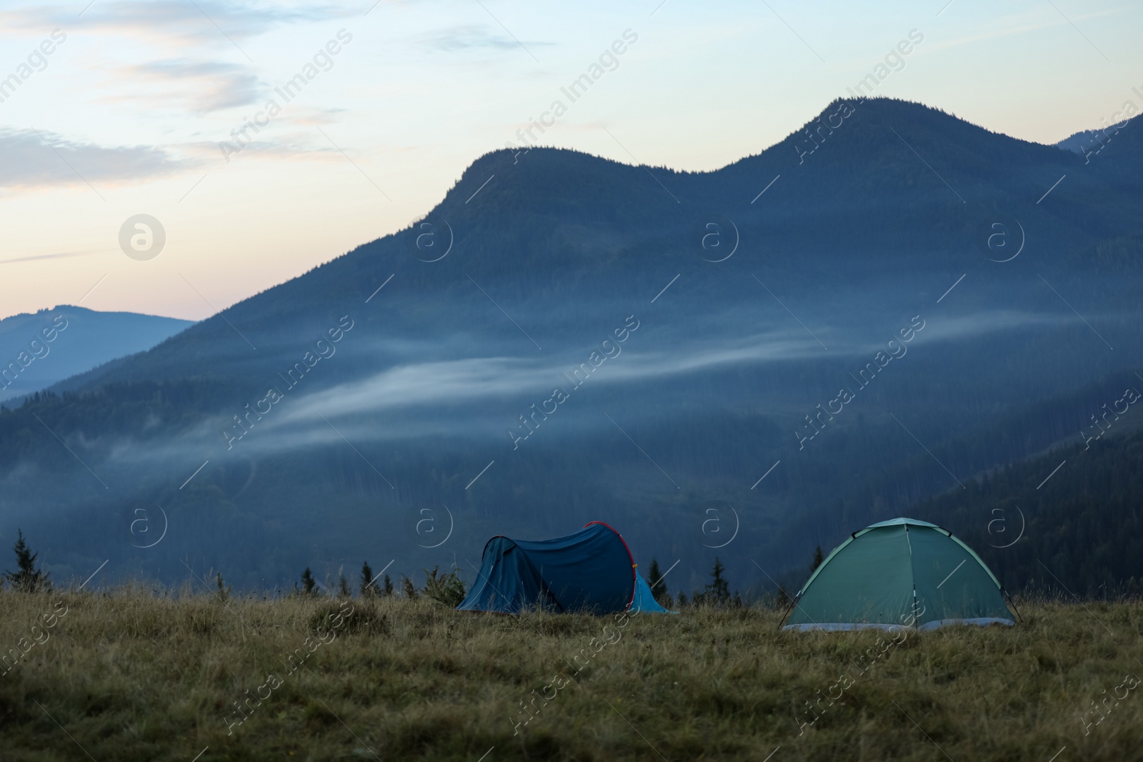 Photo of Camping tents in mountains on early morning