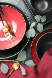 Photo of Flat lay composition with stylish ceramic plates and floral decor on grey table