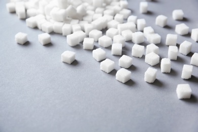 Photo of Refined sugar cubes on grey background