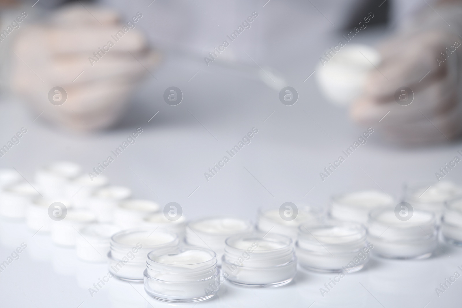 Photo of Jars with different cosmetic products in laboratory