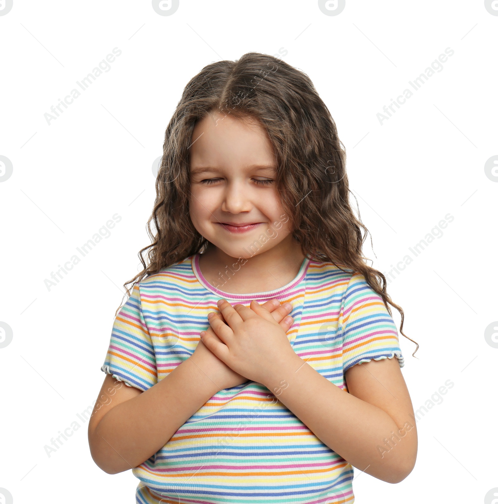 Photo of Cute grateful little girl with hands on chest, white background